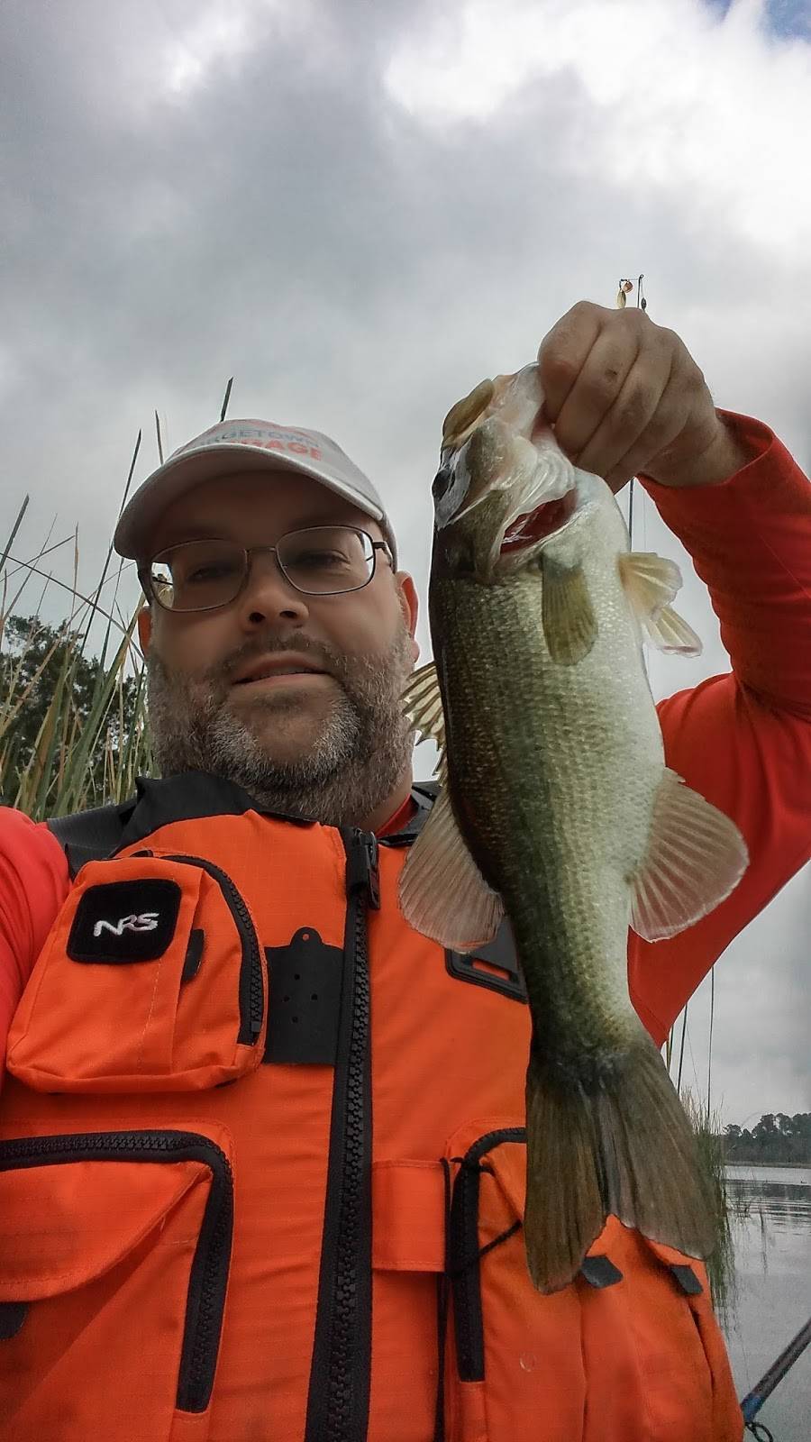 Holding Largemouth bass while kayak fishing Lake Bastrop Texas